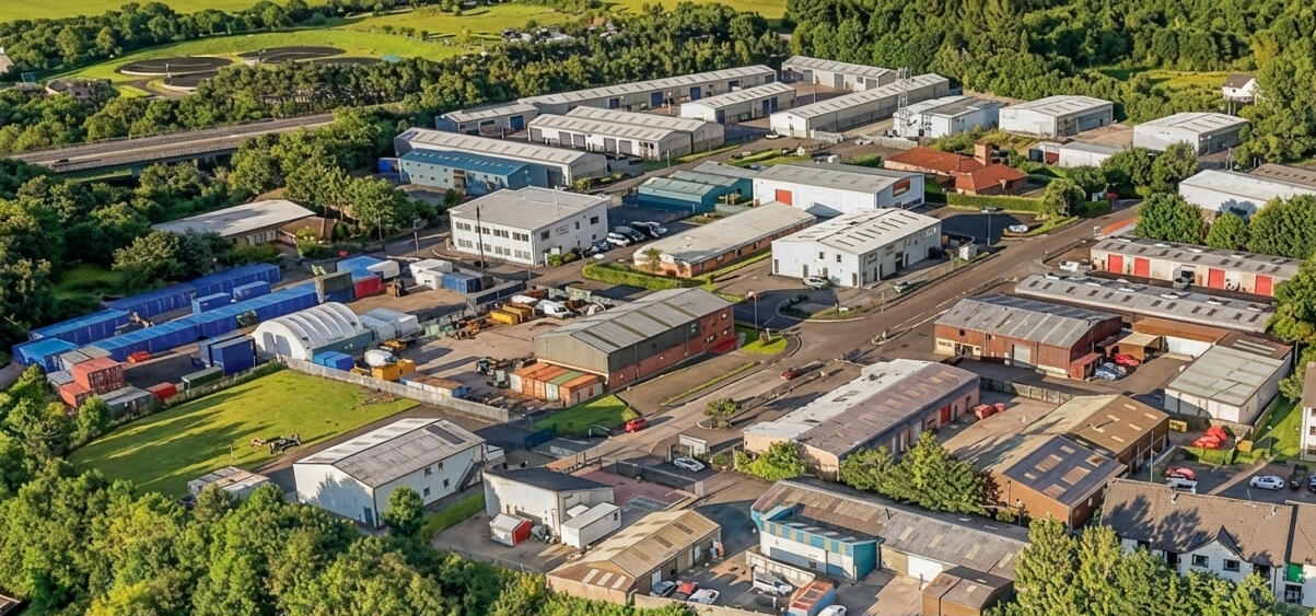 Aerial Overview of Mill Road Industrial Estate Linlithgow Aerial view of Mill Road Industrial Estate in Linlithgow showing industrial units, internal roads, and surrounding residential areas.